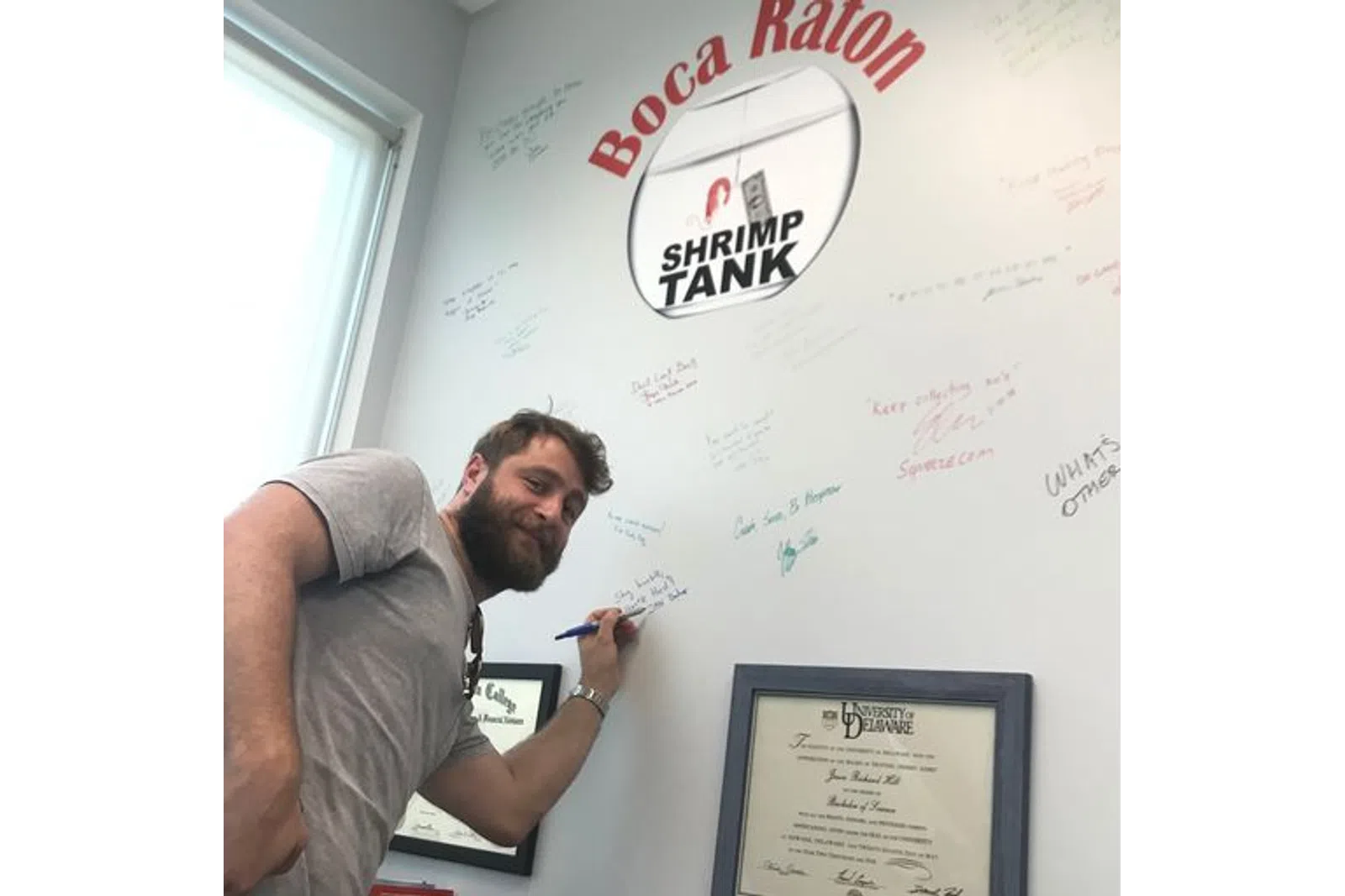 a man writing on a white board