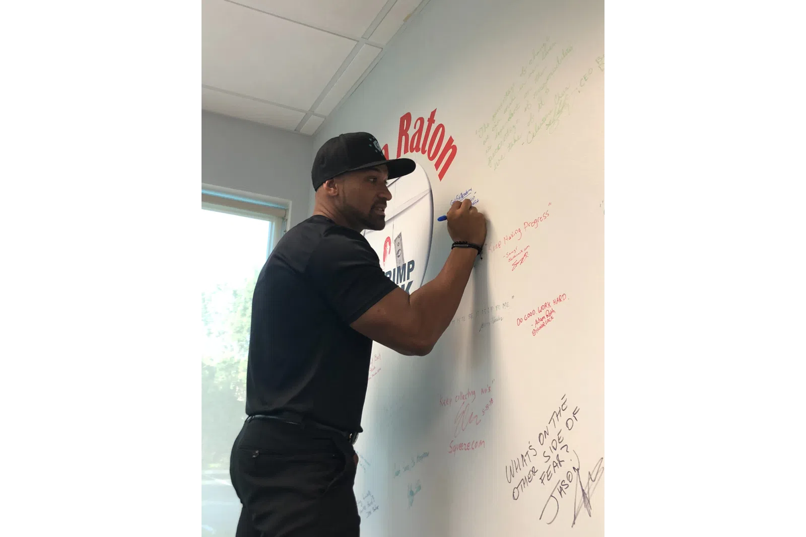 a man writing on a whiteboard