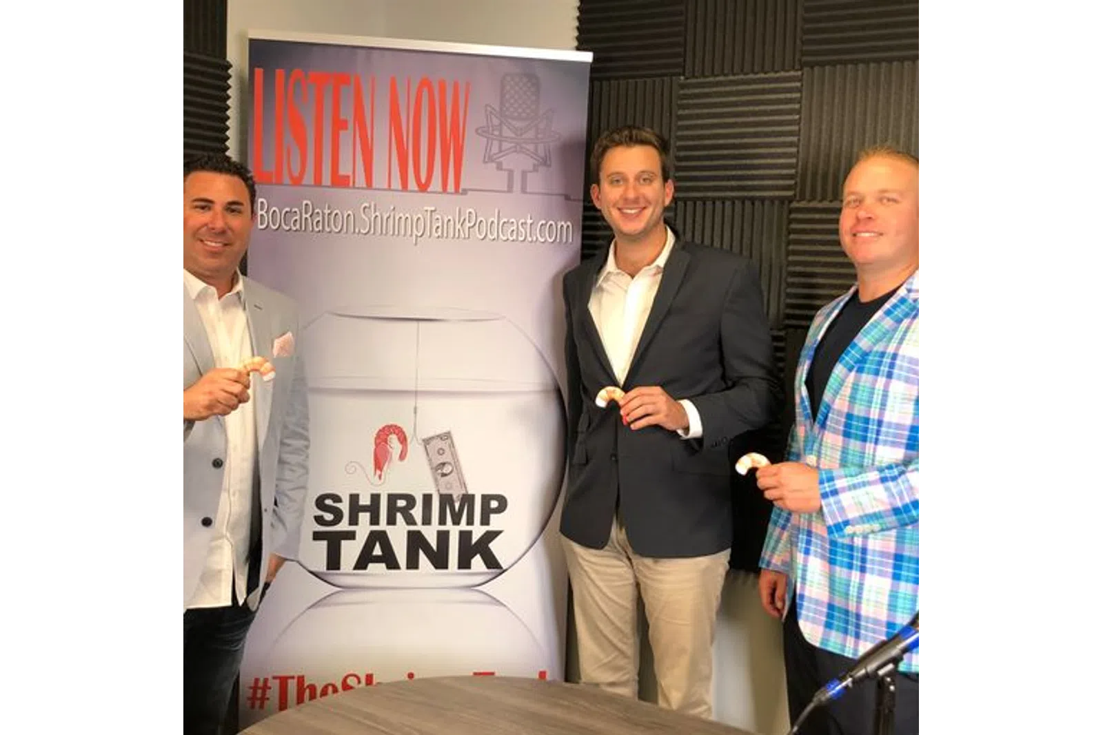 a group of men standing next to a sign