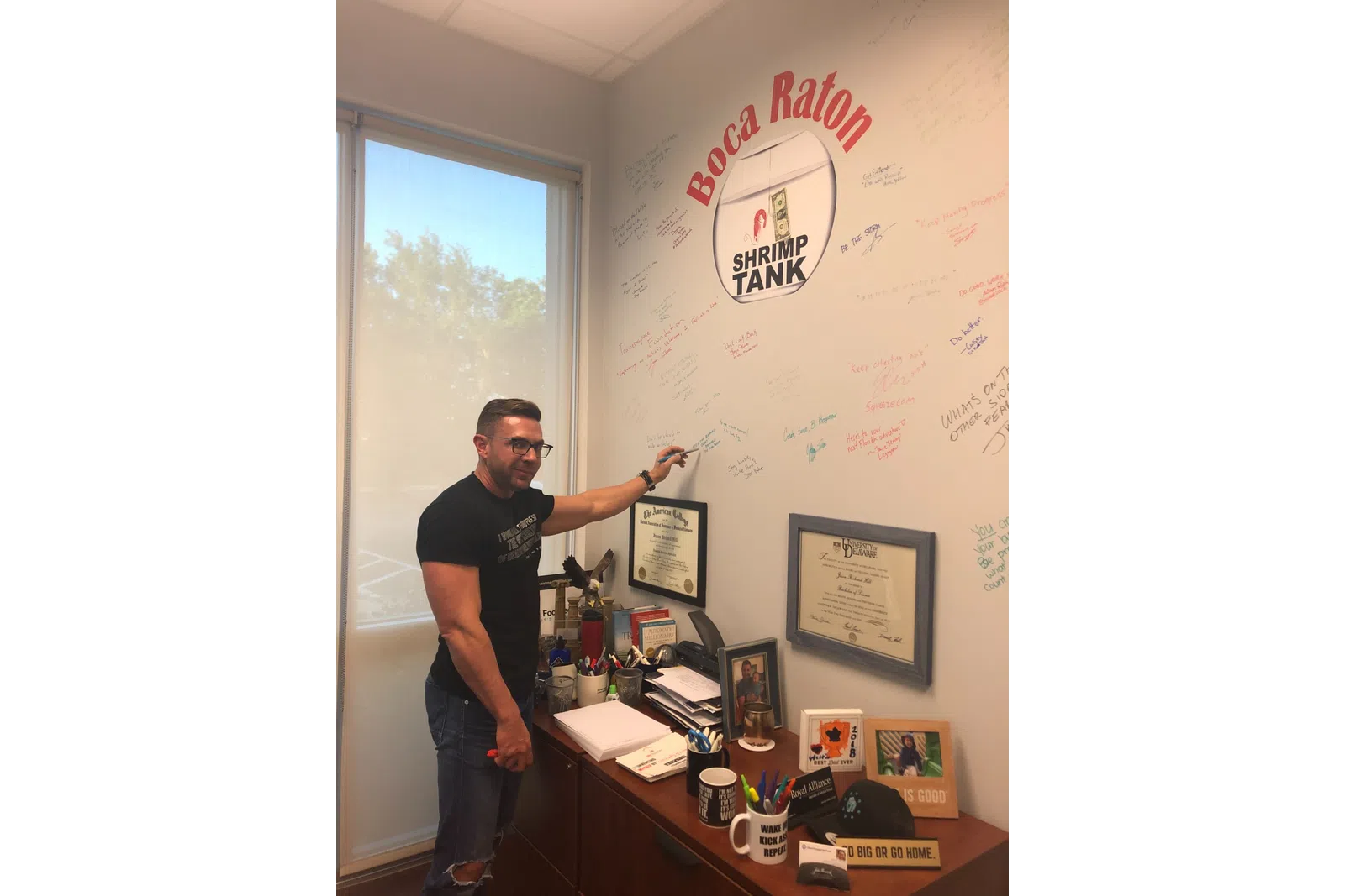 a man writing on a whiteboard