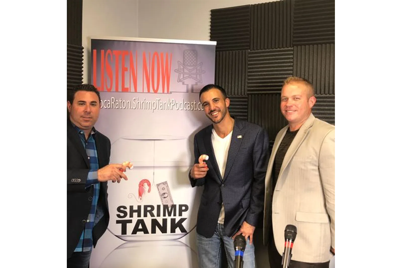 a group of men standing next to a sign