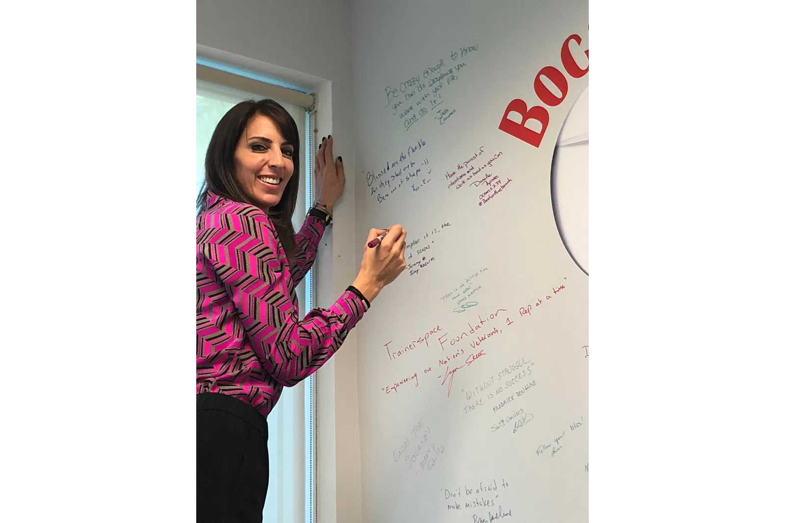 a person writing on a whiteboard