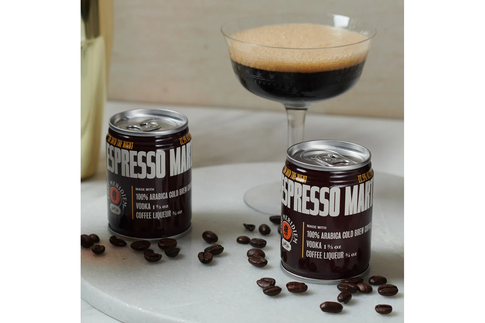a group of coffee beans next to a glass of coffee