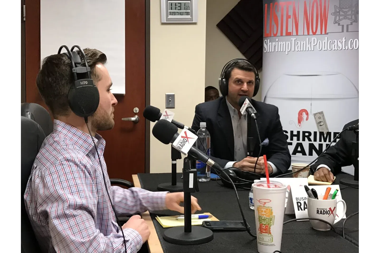 Ted Jenkin wearing headphones sitting at a table with a microphone