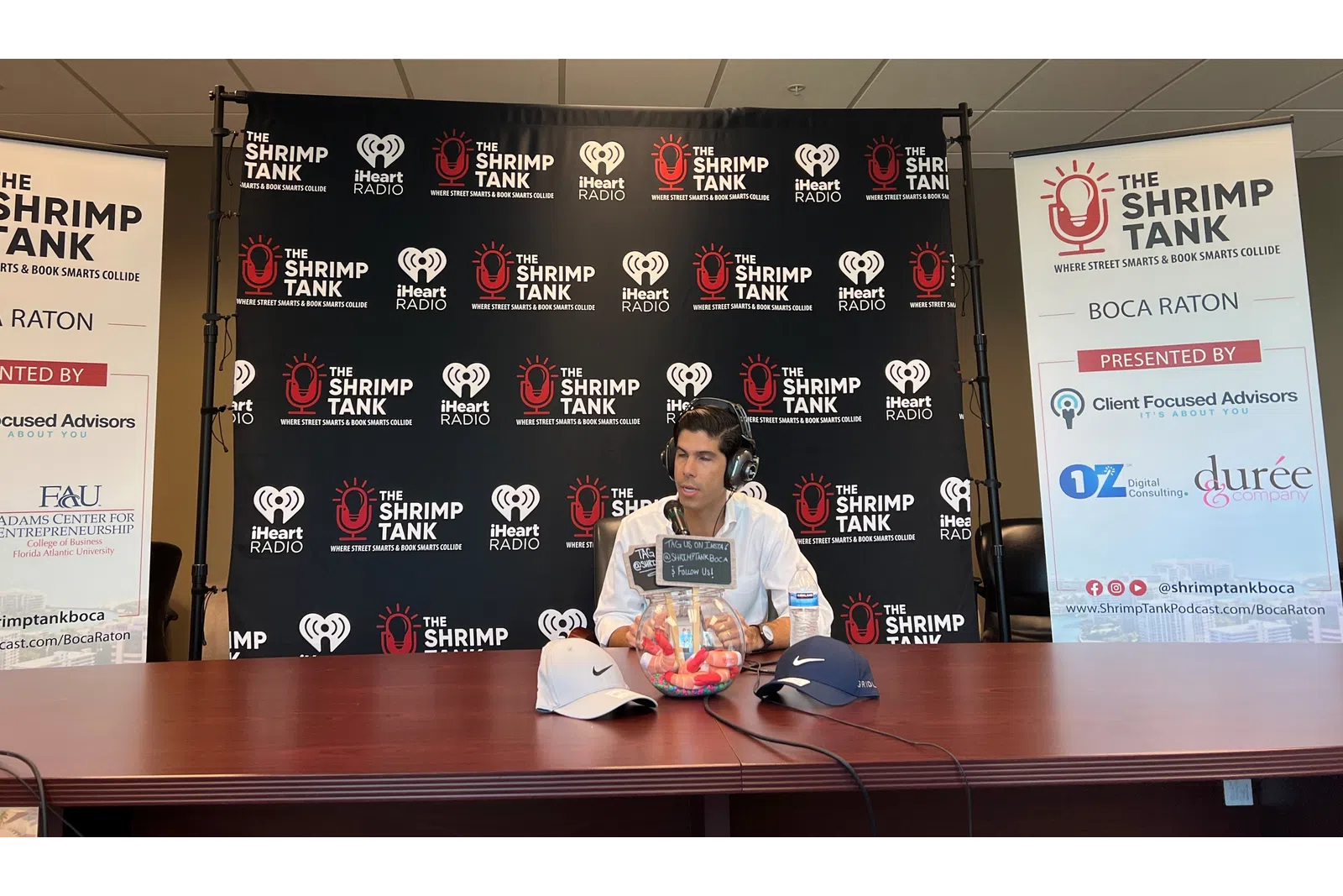 a person sitting at a desk with headphones on