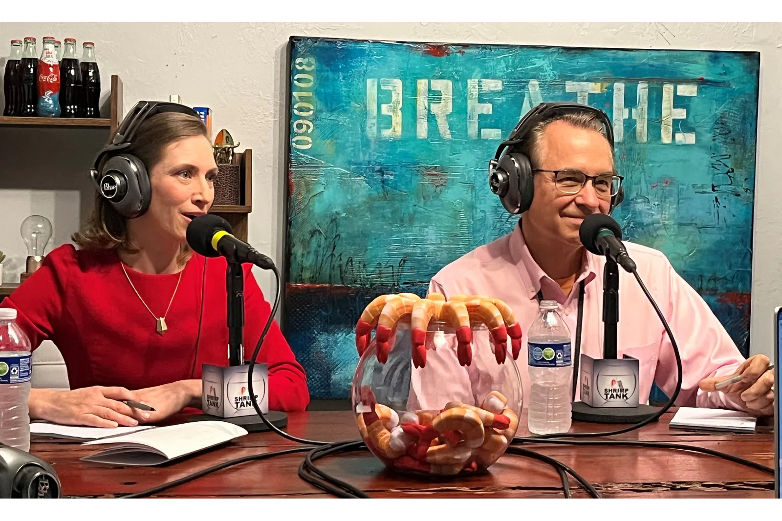 Doug Meadows et al. wearing headphones and sitting at a table with food