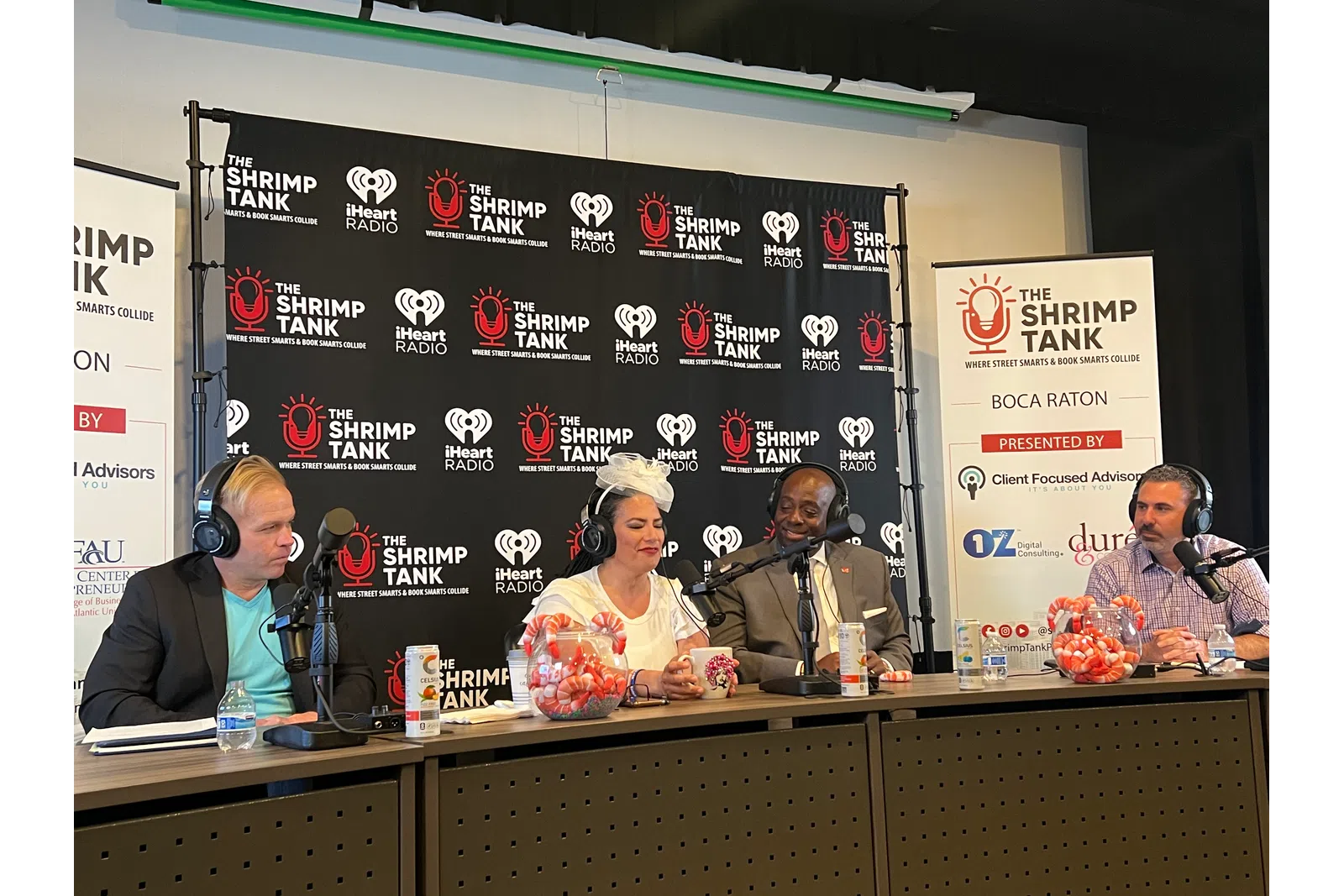 a group of people sitting at a table with microphones