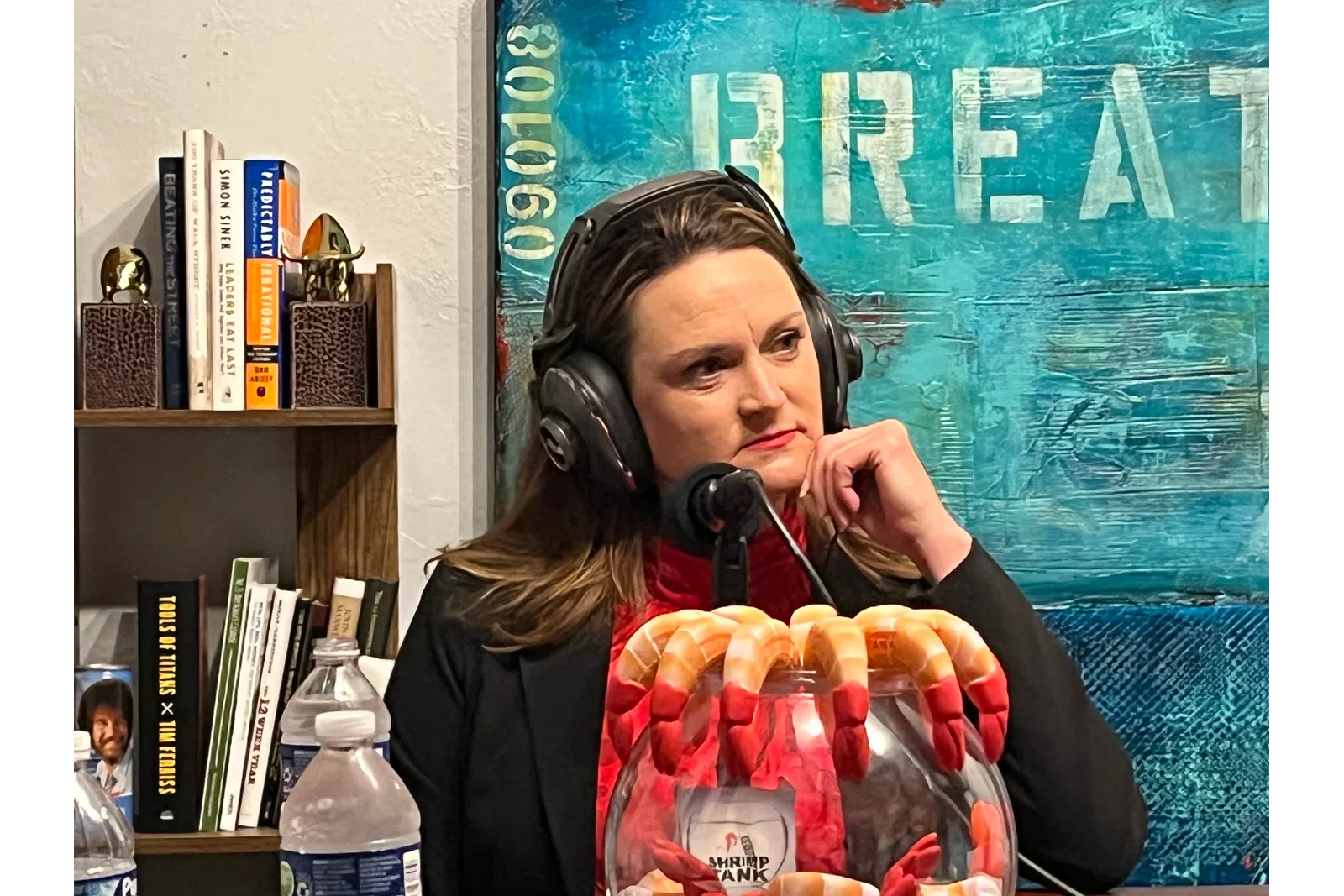 a woman wearing headphones and holding a bag of candy