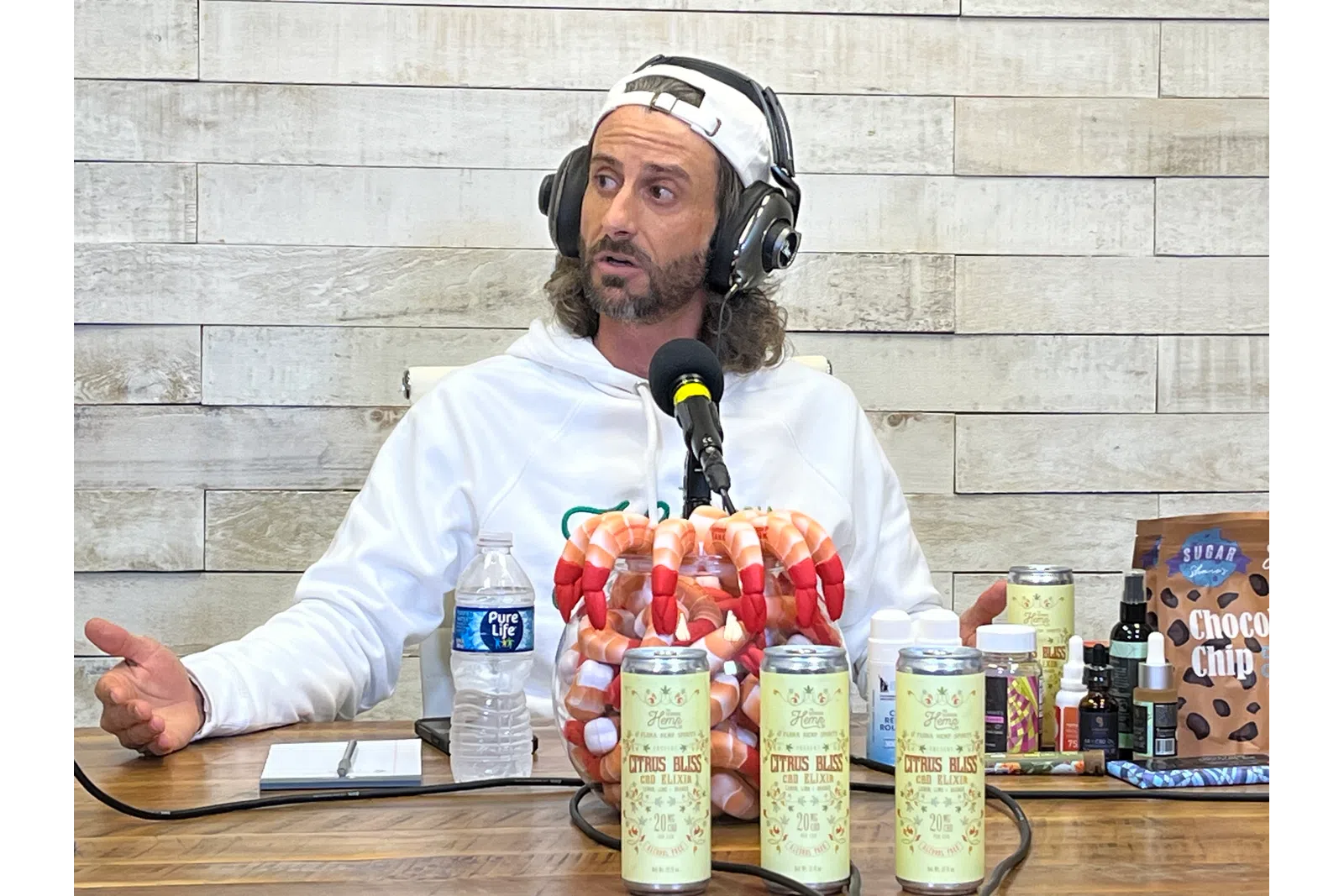 a person wearing headphones and sitting at a table with a microphone
