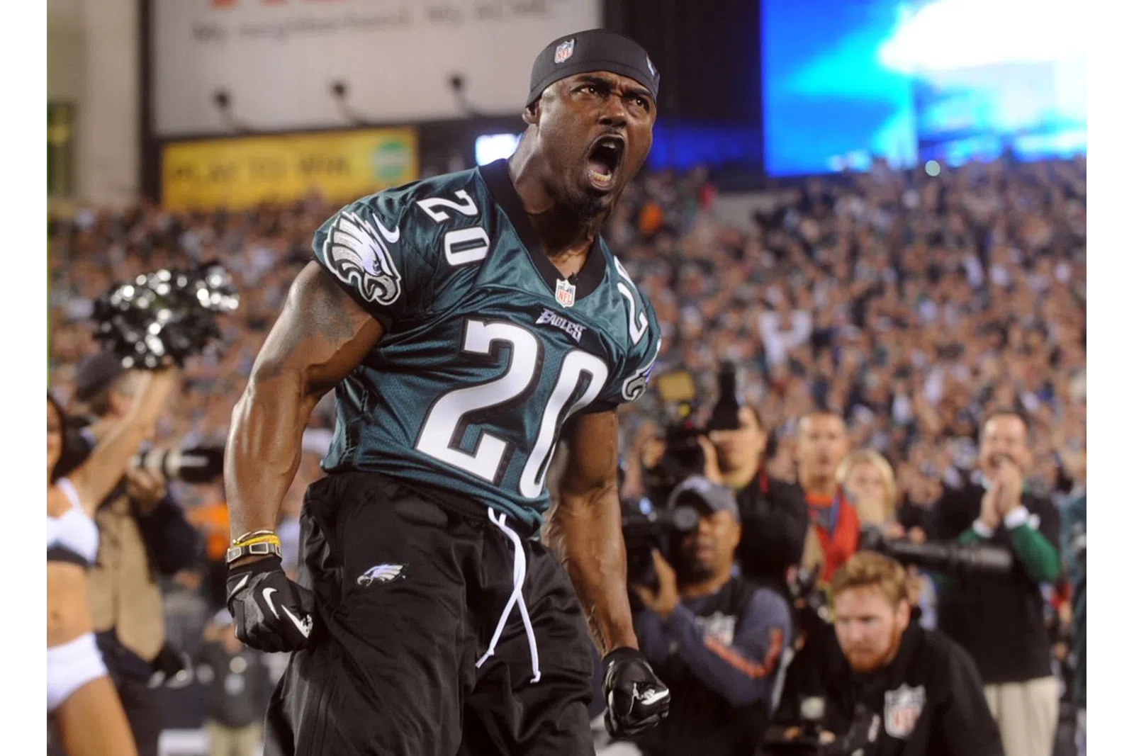 Brian Dawkins wearing a jersey and running