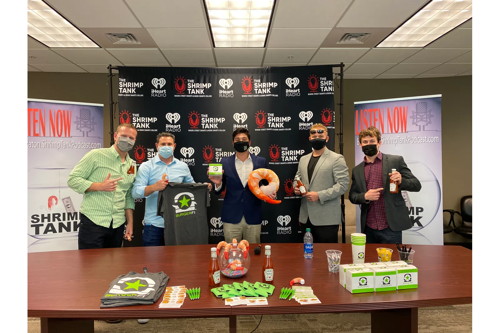 a group of people holding objects posing for the camera