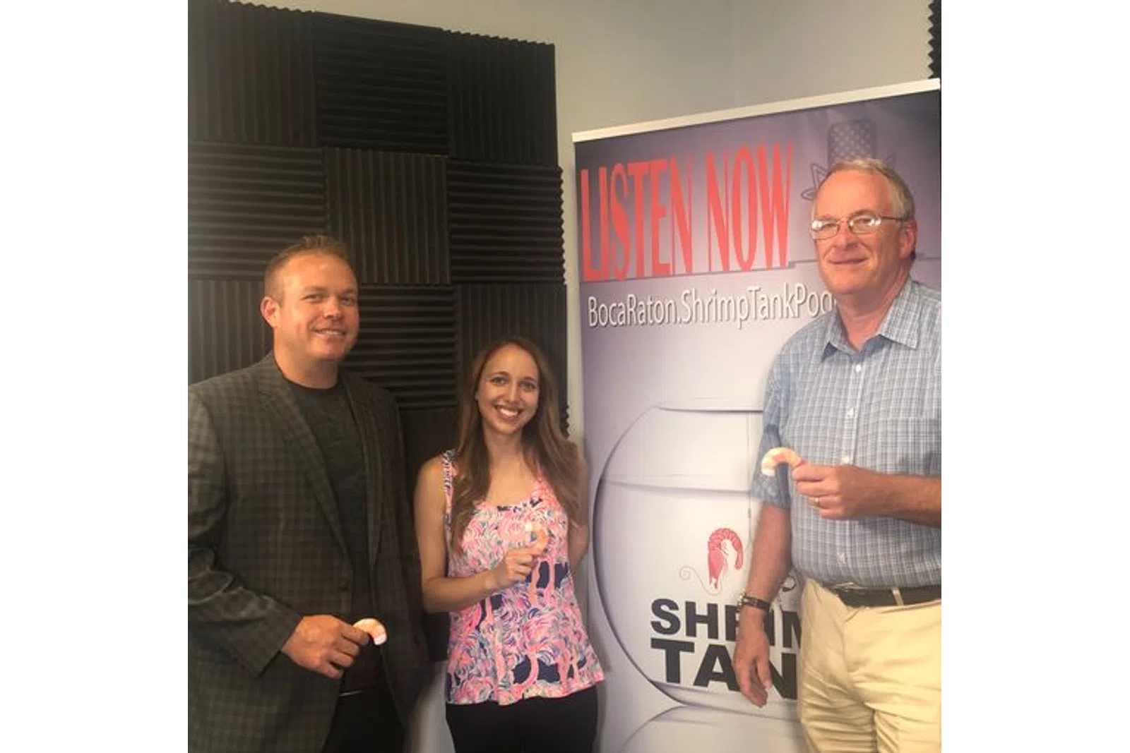 a group of people standing in front of a sign