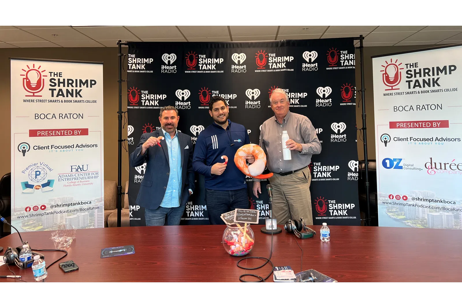 a group of men standing next to a table with a large balloon