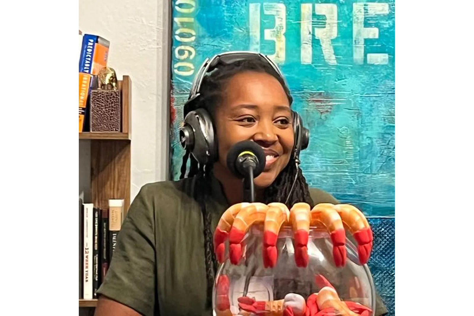 a person wearing headphones and holding a box of hot dogs