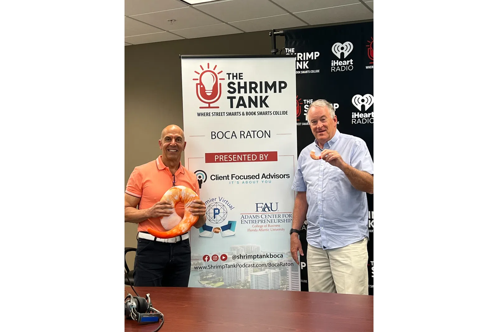 a couple of men standing next to a sign