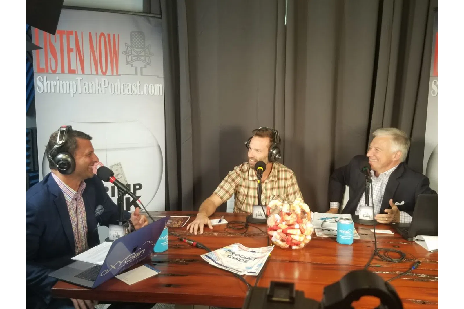 a group of people sitting at a table with microphones