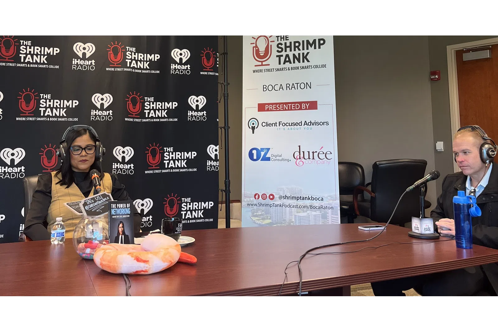 a couple of women wearing headphones and sitting at a table