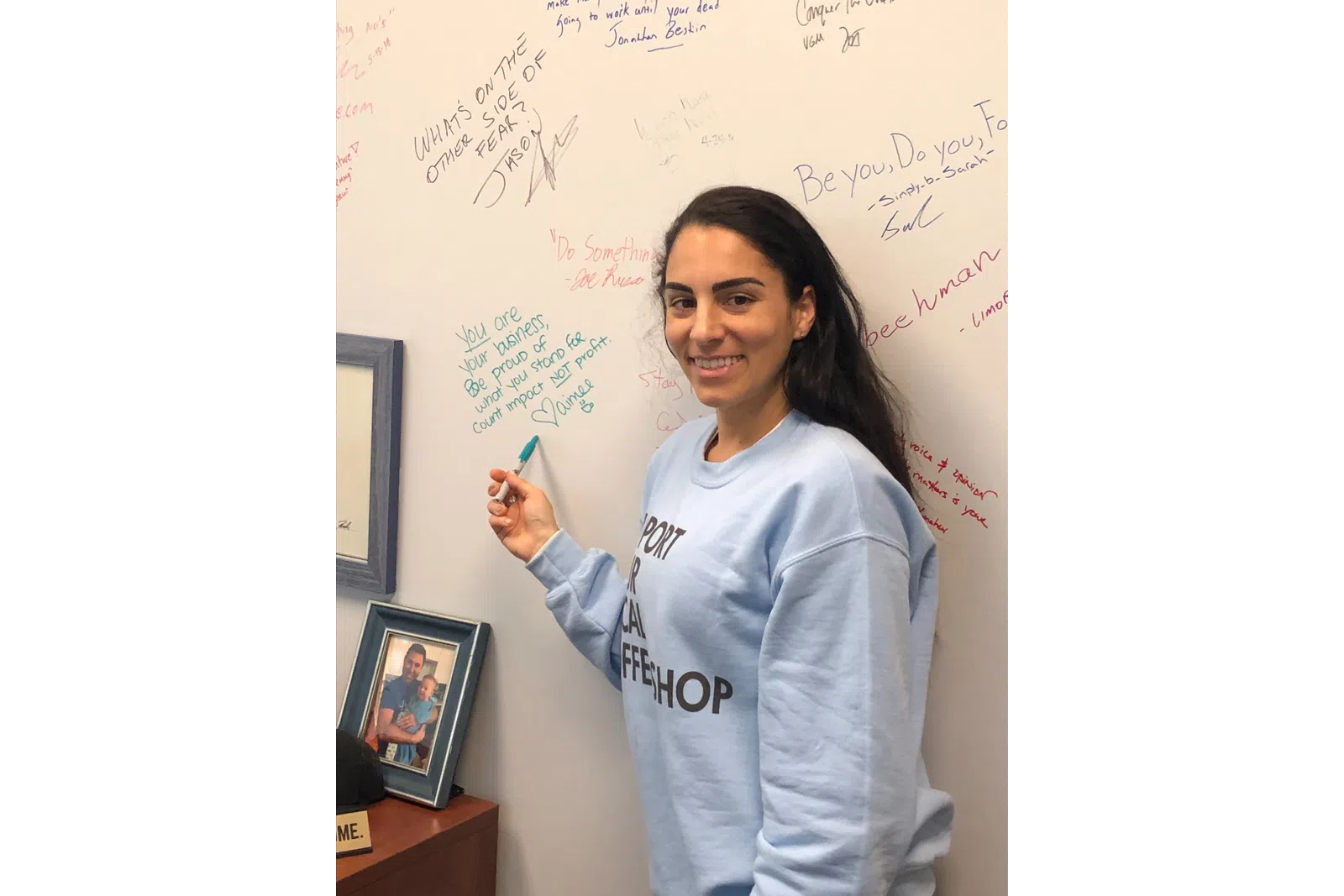 a person standing in front of a whiteboard