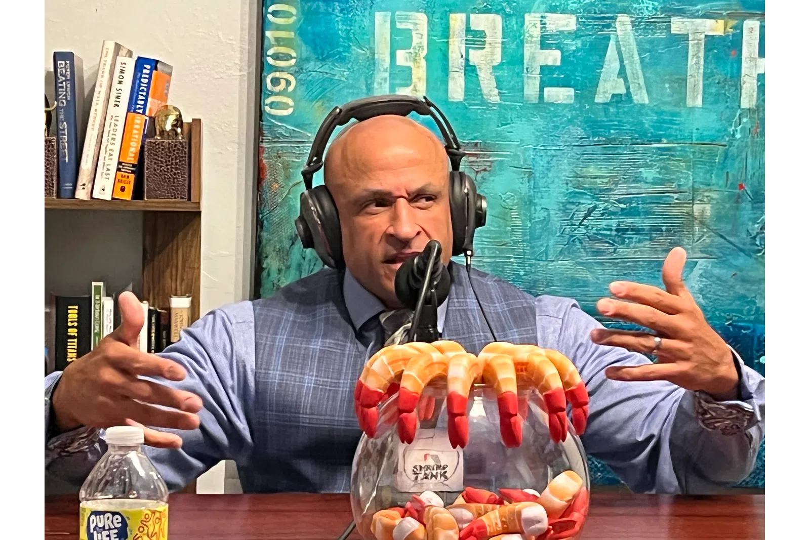 a person wearing headphones and holding a microphone and a basket of food