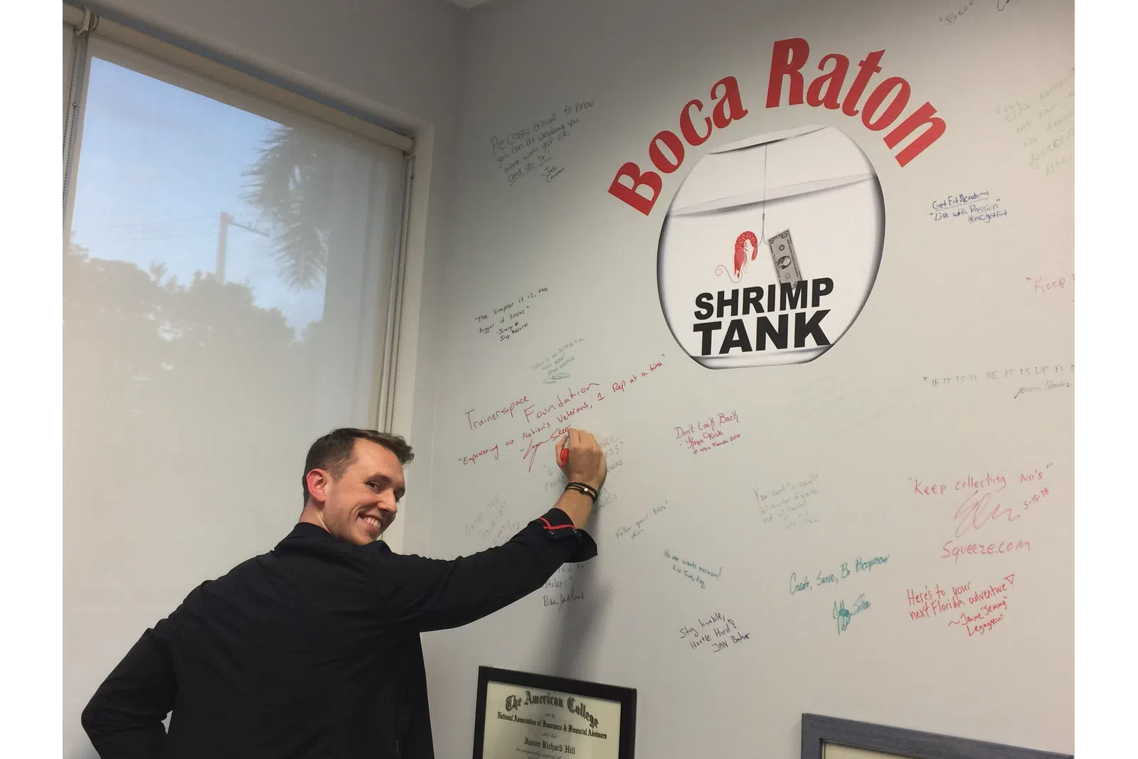 a man pointing to a whiteboard