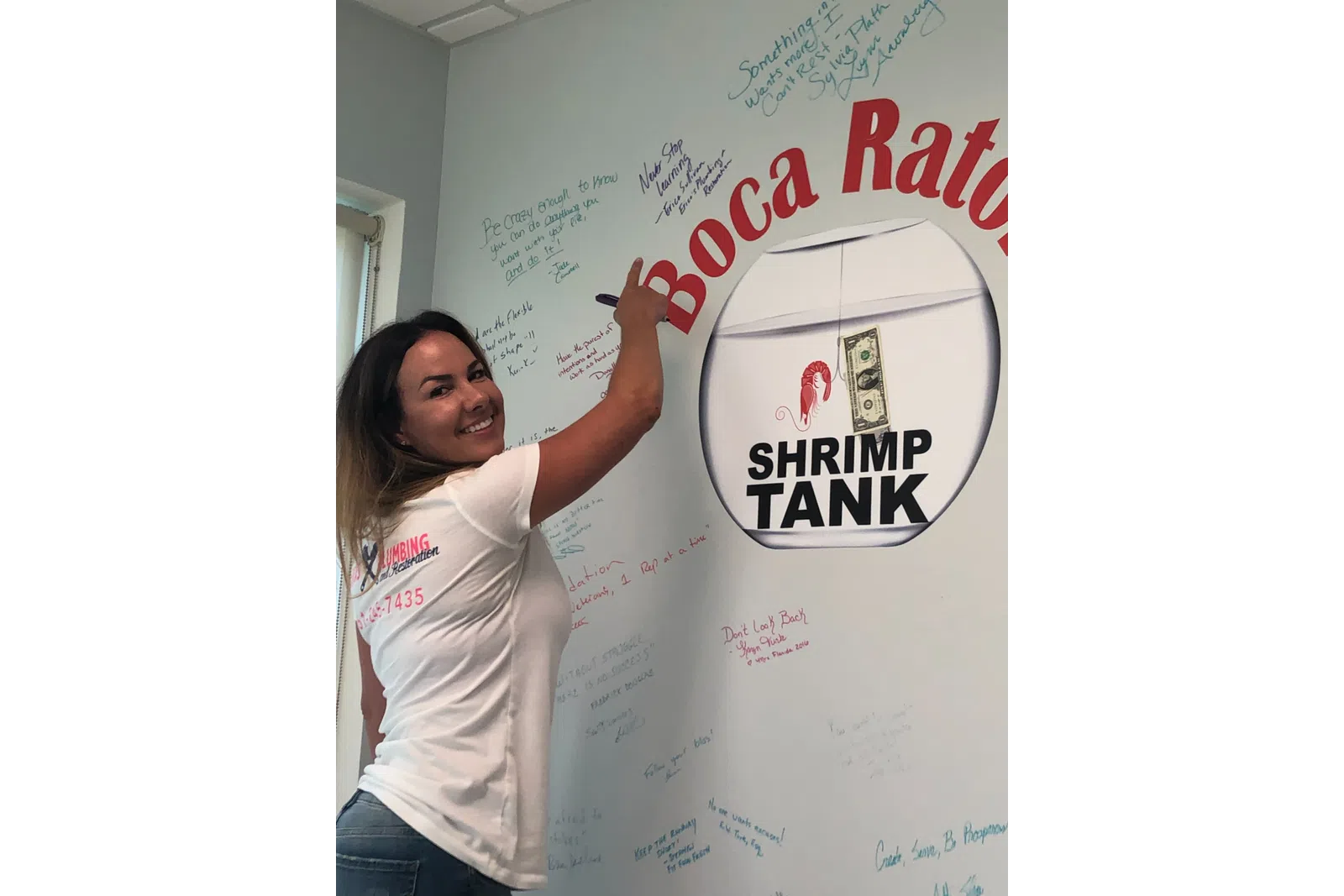 a person posing in front of a white board with writing on it