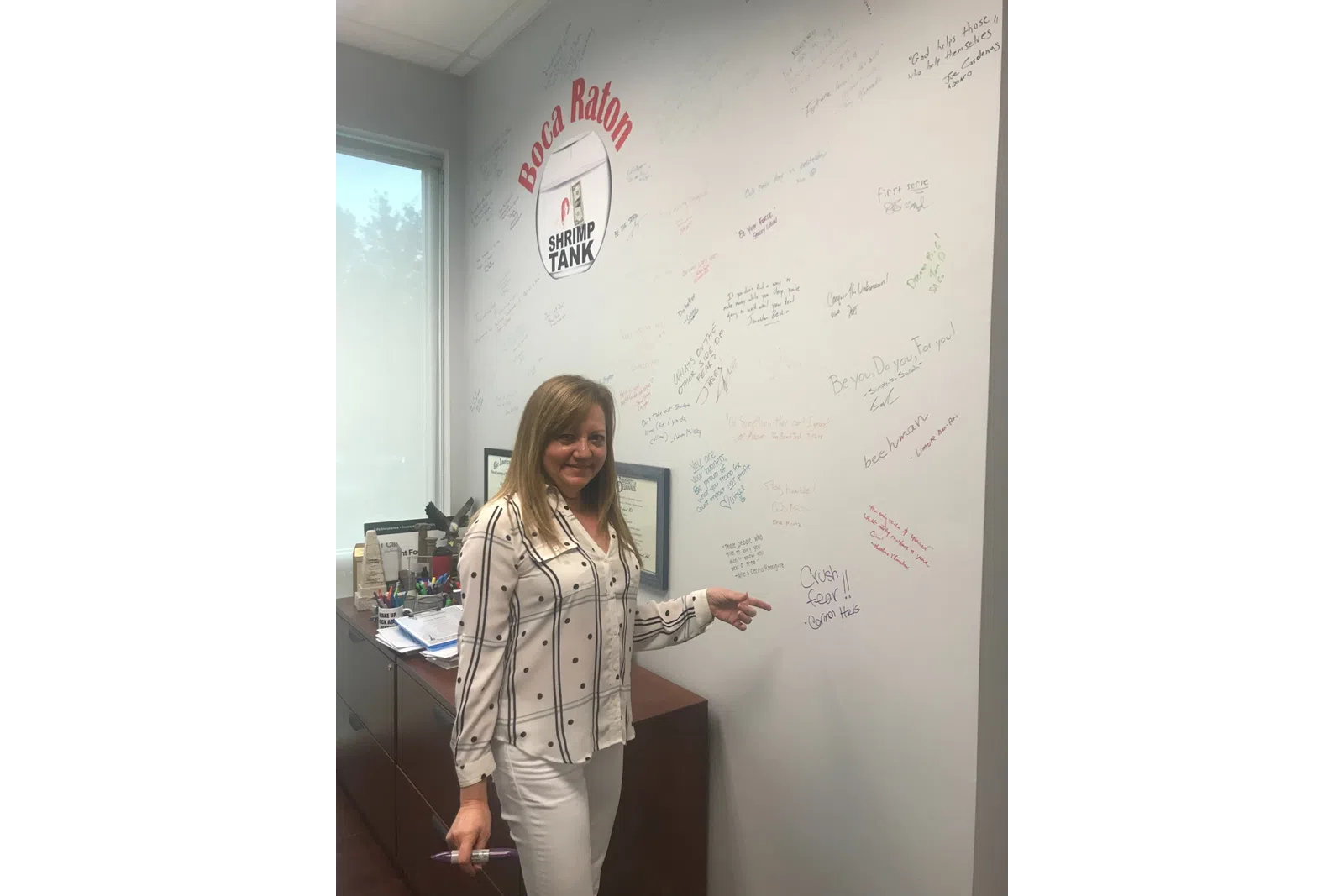 a person writing on a whiteboard