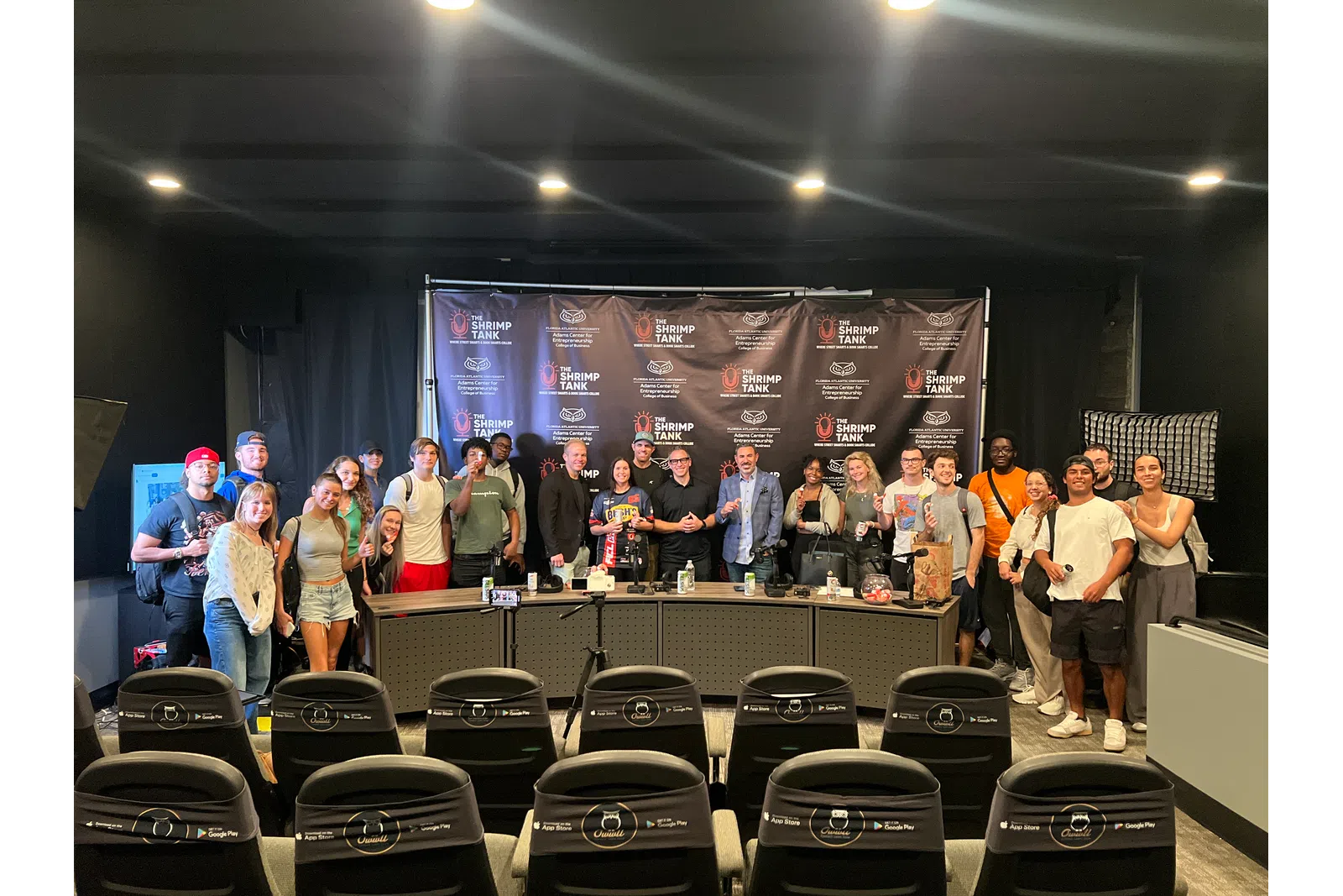 Group photo of participants at a film event, gathered around a panel discussion table.
