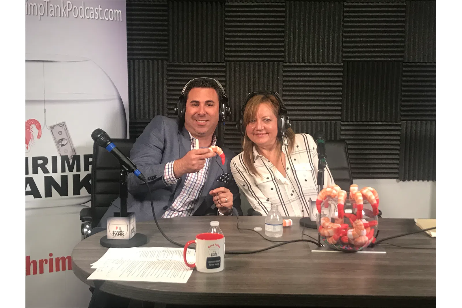 a couple of women sitting at a table with microphones