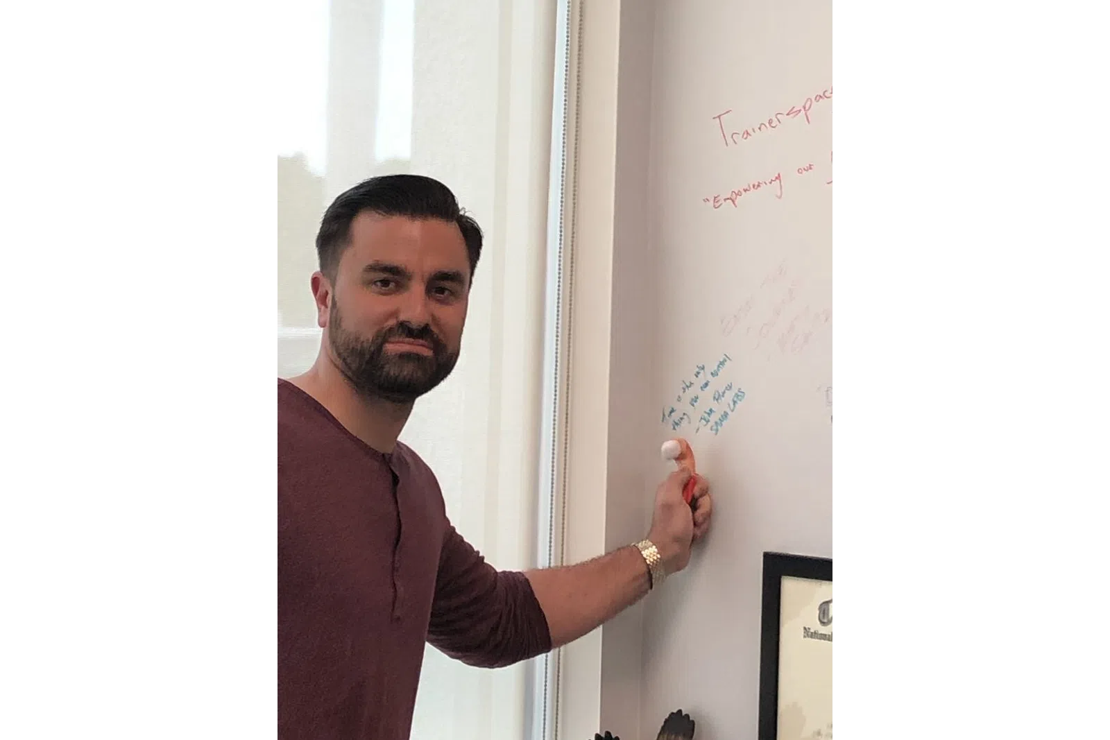 a man writing on a white board