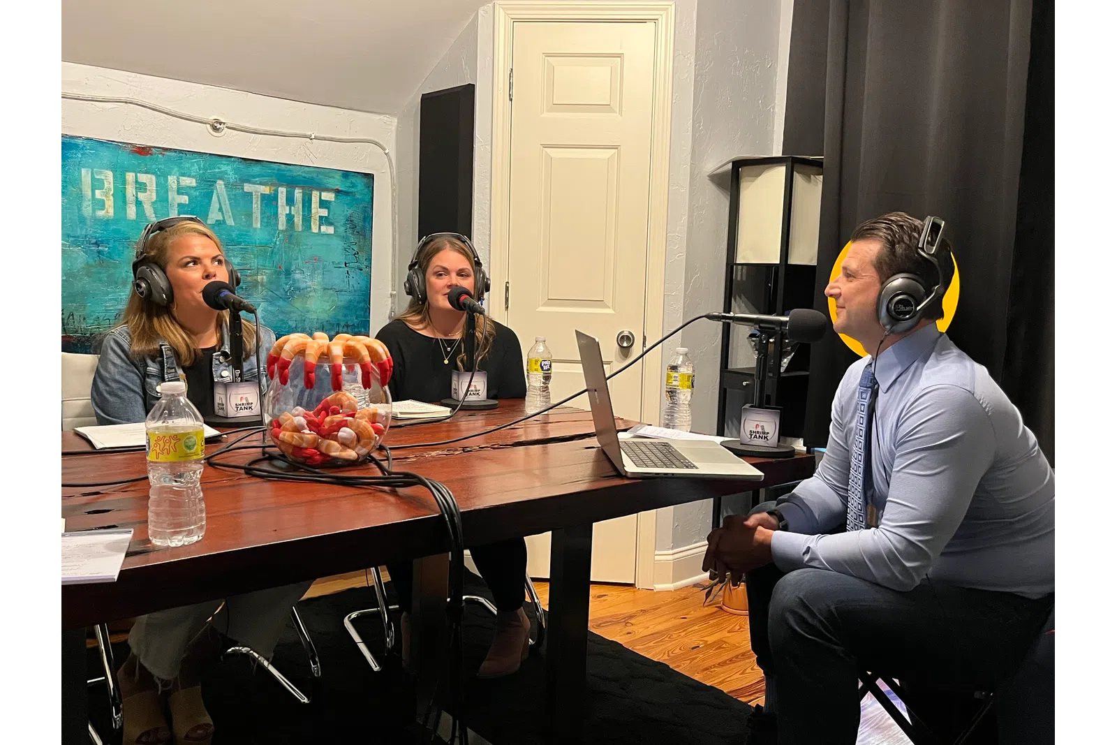 a group of people sitting at a table with microphones