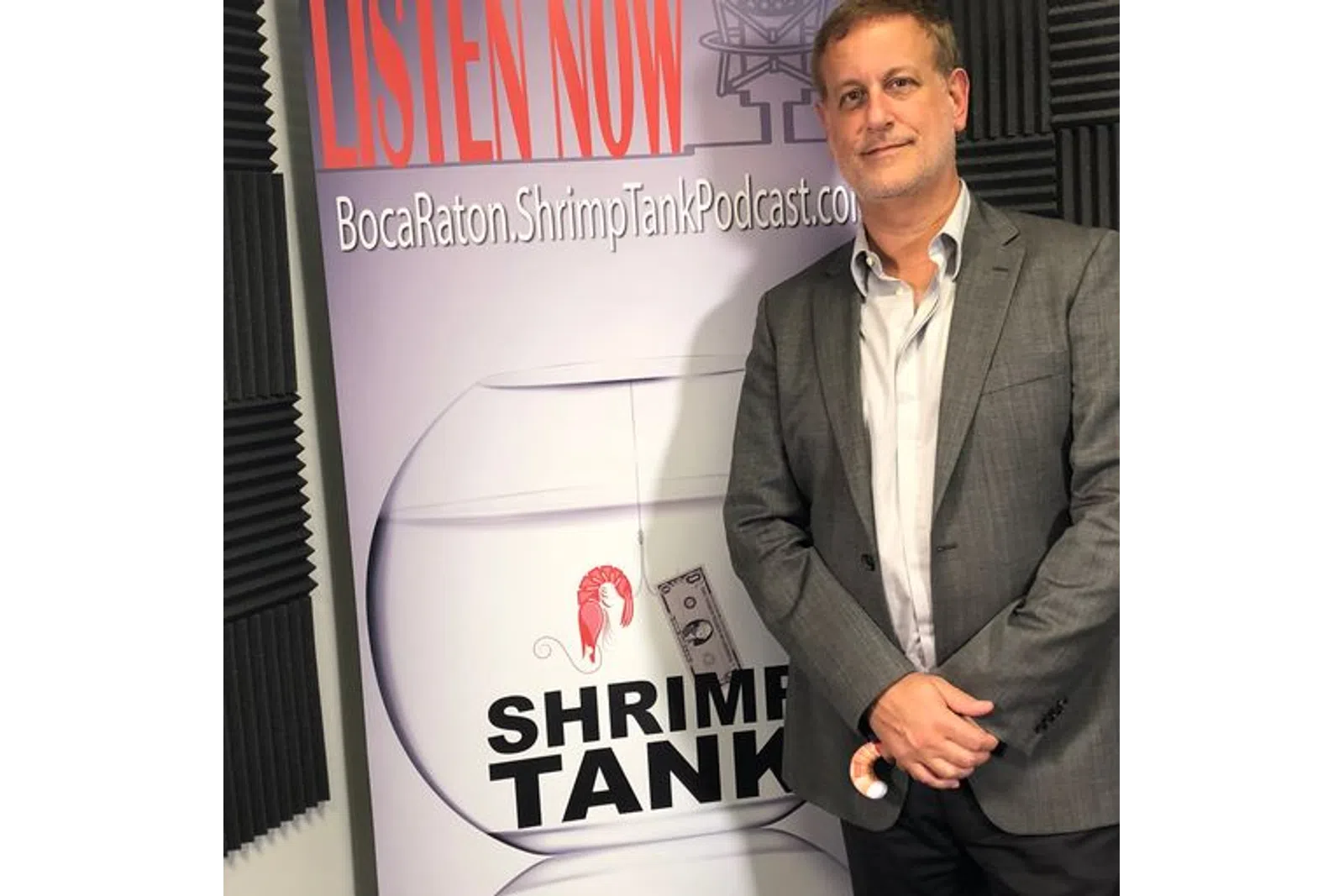 a man standing next to a poster