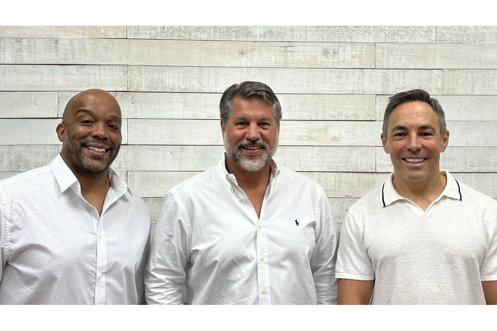 a group of men in white shirts