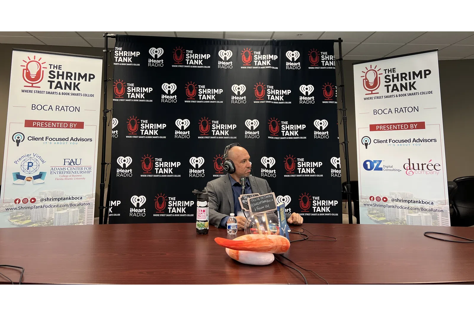 a person sitting at a table with a bowl of food and a sign