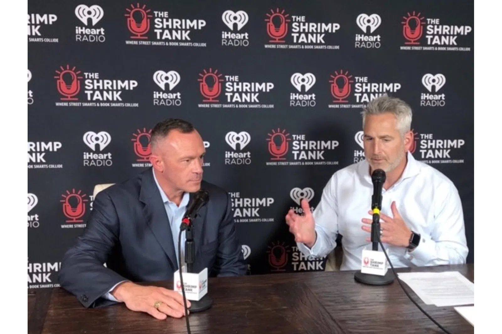 Paul Geyer et al. sitting at a table with microphones