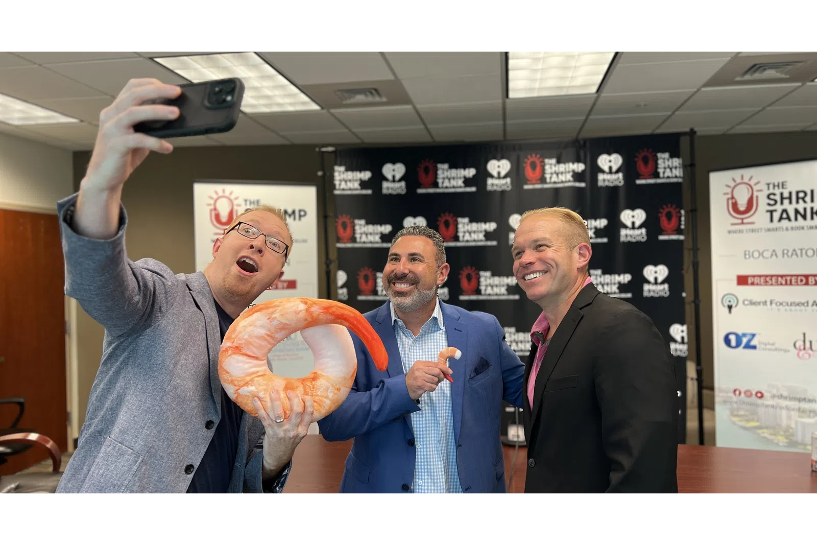 a group of men holding up a large piece of meat