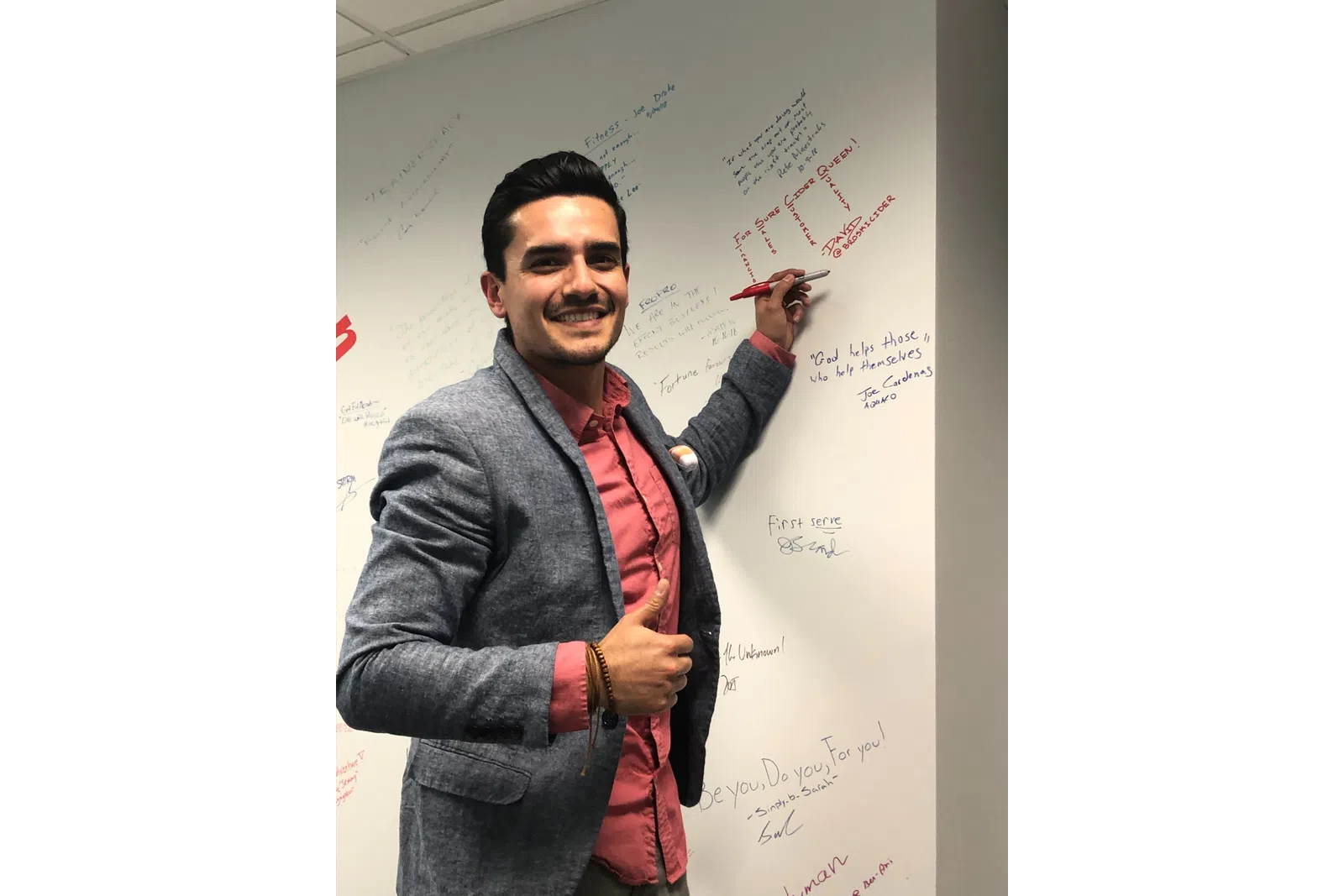 a person writing on a whiteboard