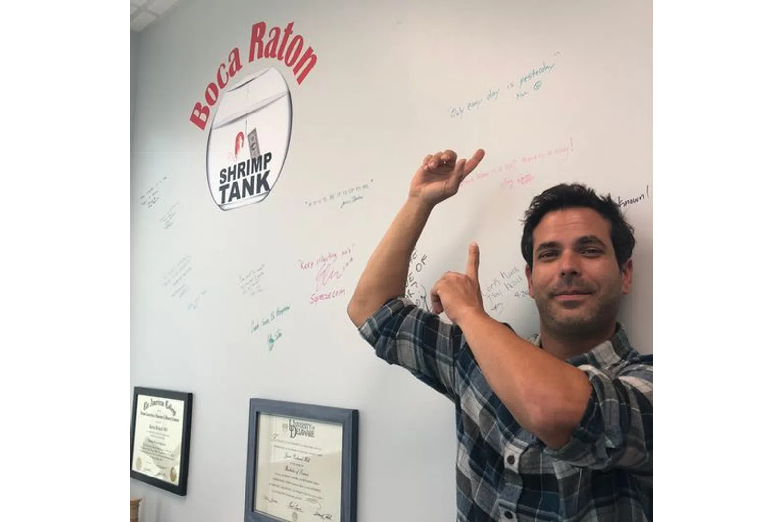 a man pointing to a whiteboard