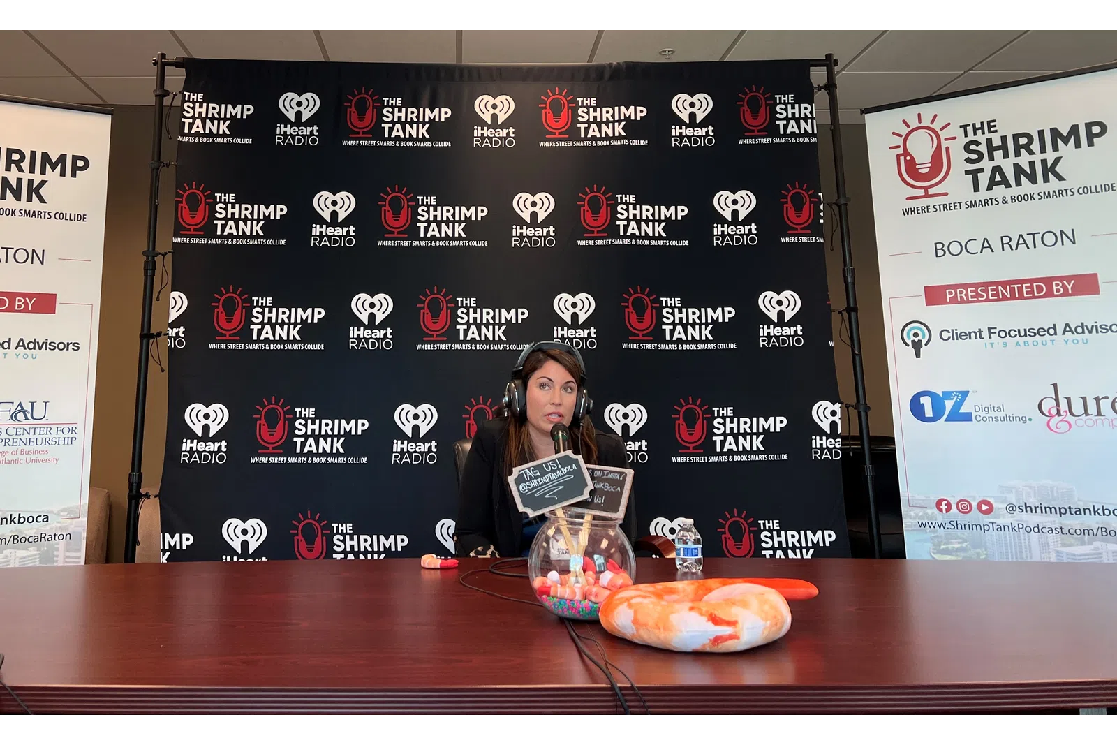 a person sitting at a table with a plate of food and a sign