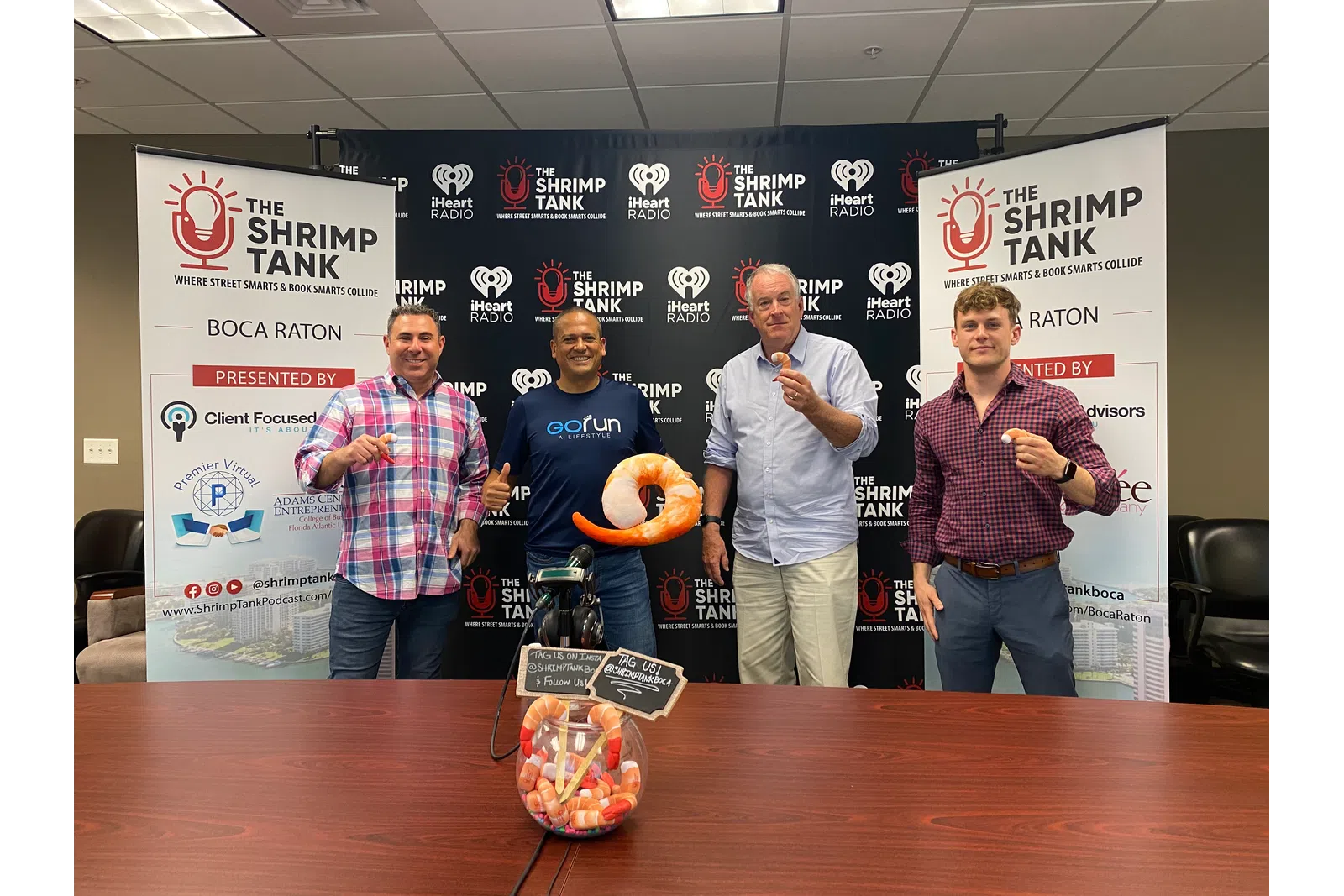 a group of men holding a large stuffed animal