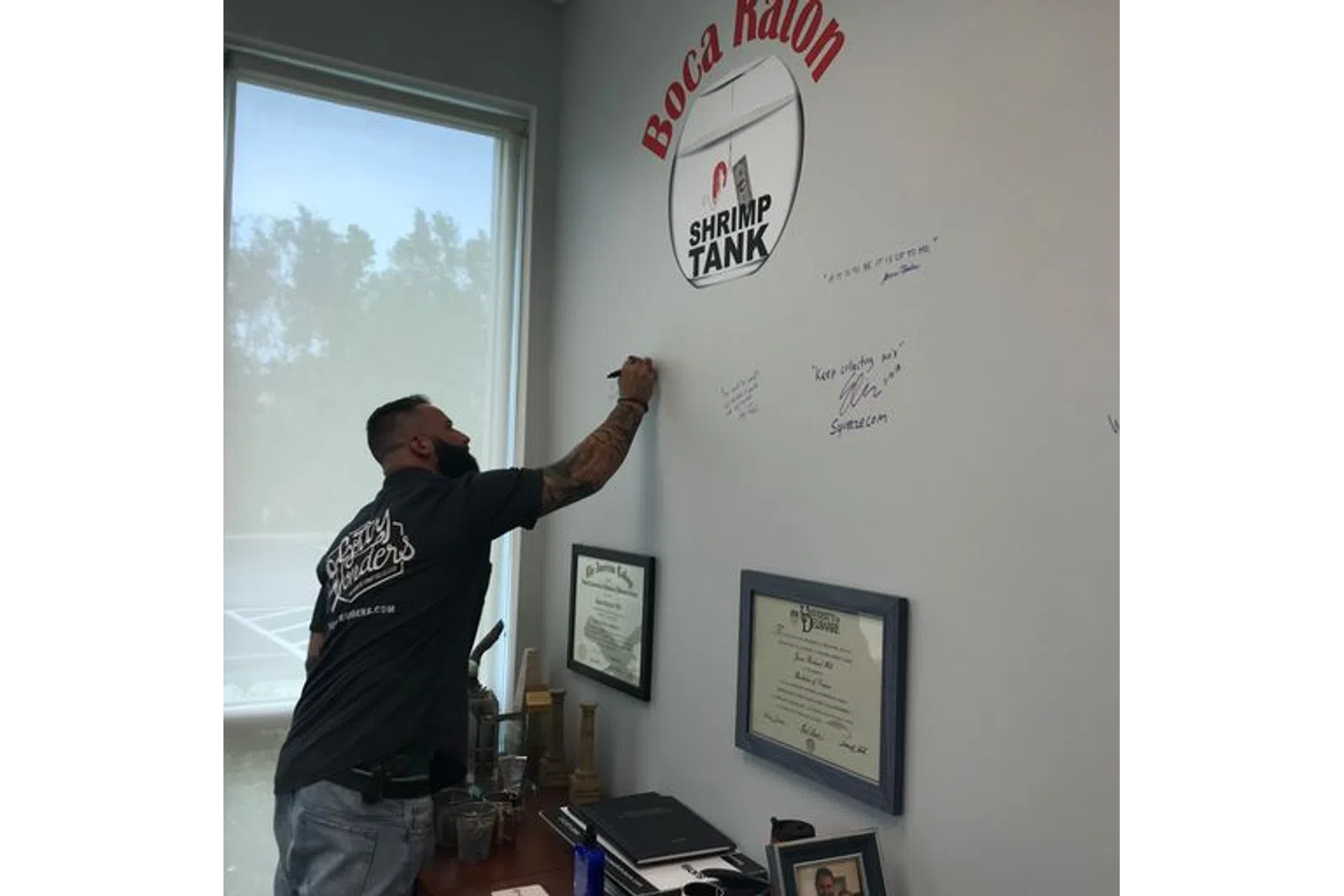 a man writing on a whiteboard