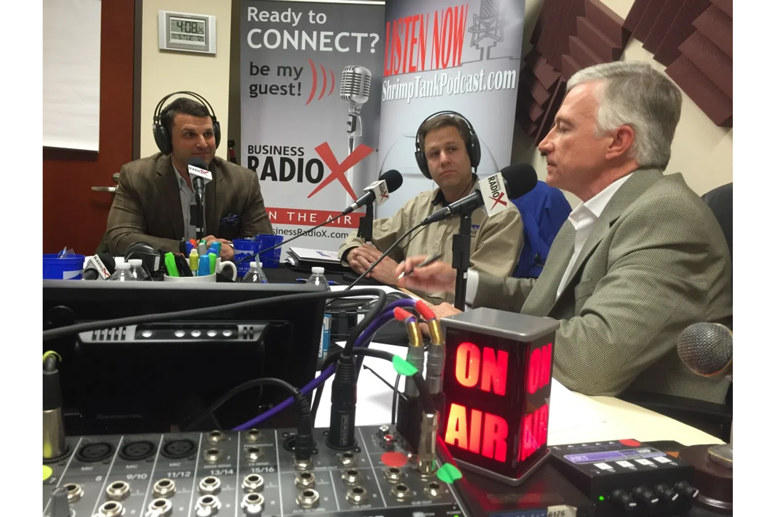 Ted Jenkin et al. sitting at a table with microphones