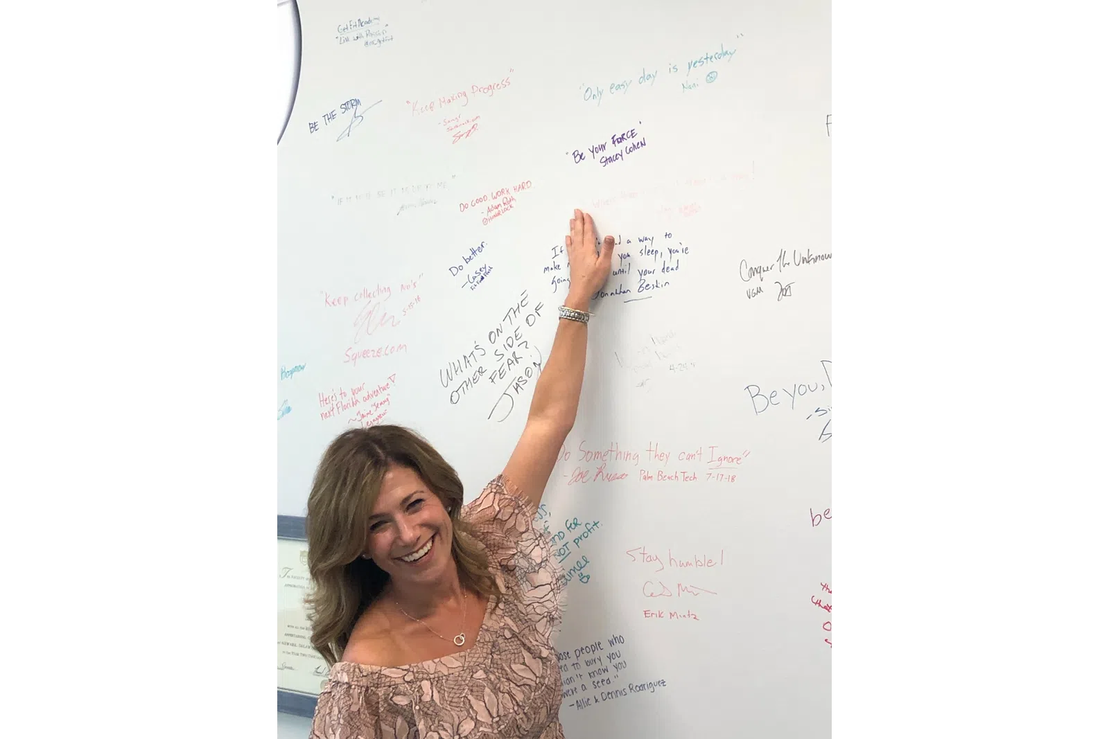 a person writing on a whiteboard