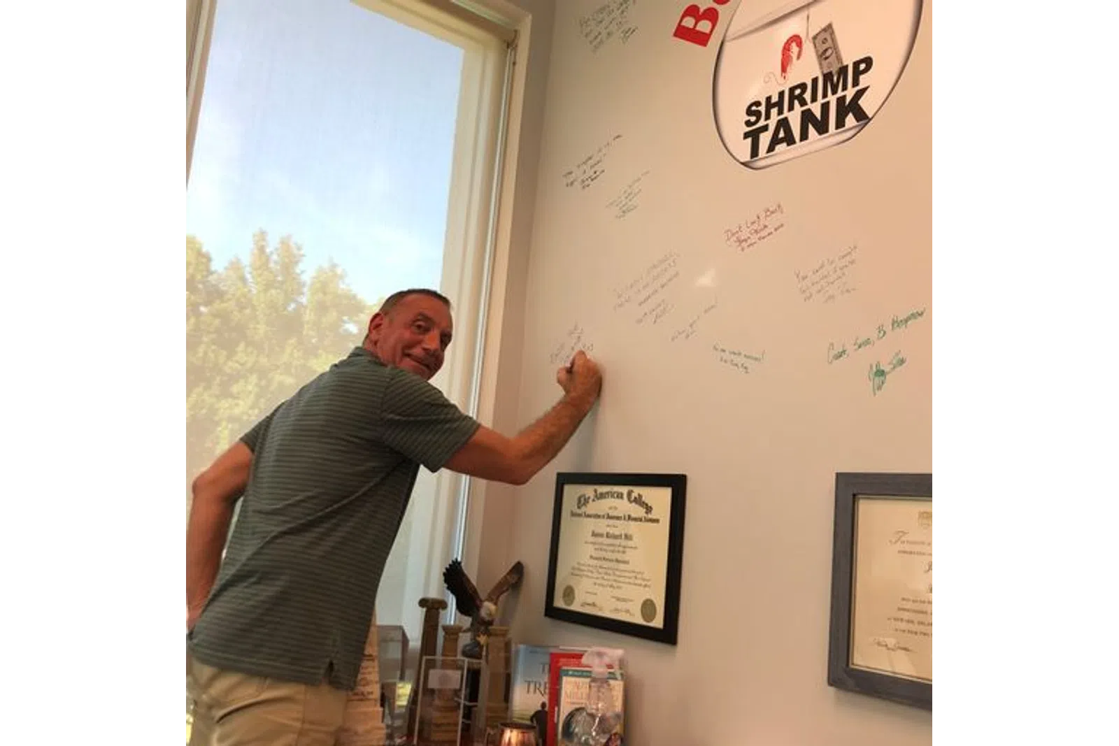 a man writing on a whiteboard