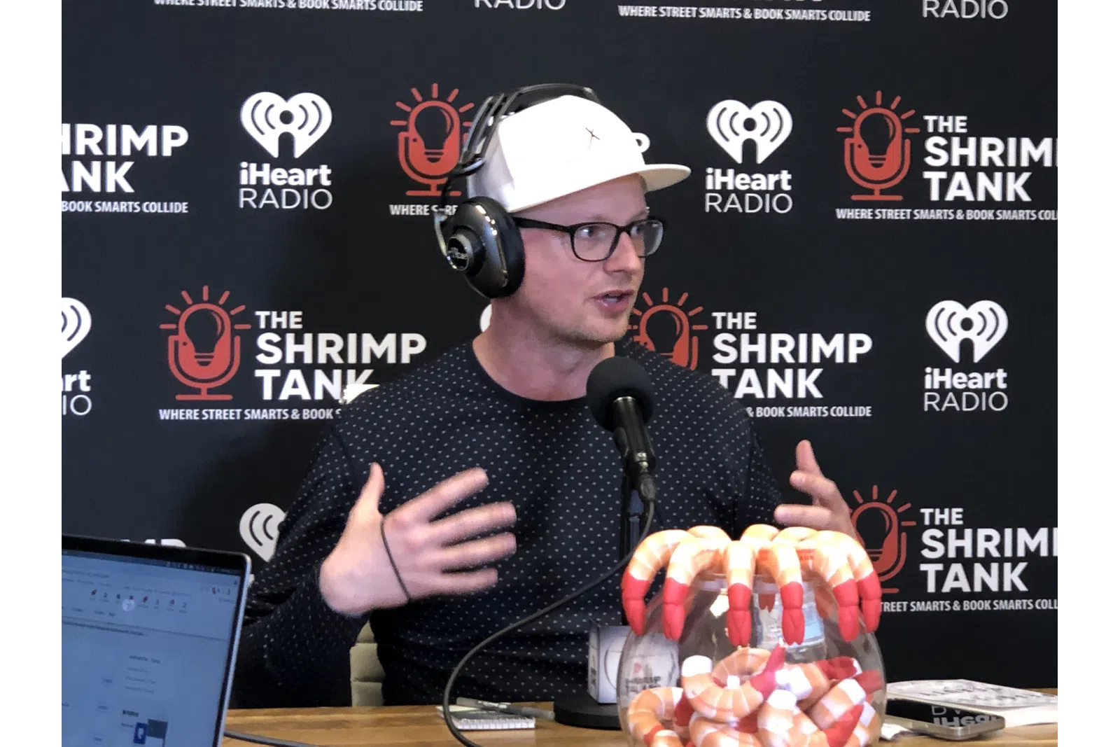 a man wearing headphones and sitting at a table with a microphone