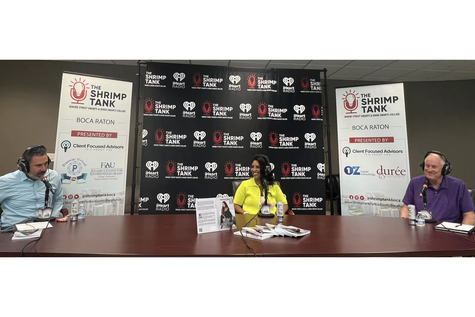 a group of people sitting at a table with microphones