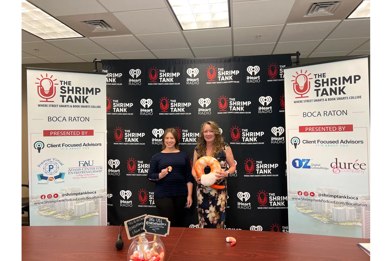 a couple of women holding a stuffed animal
