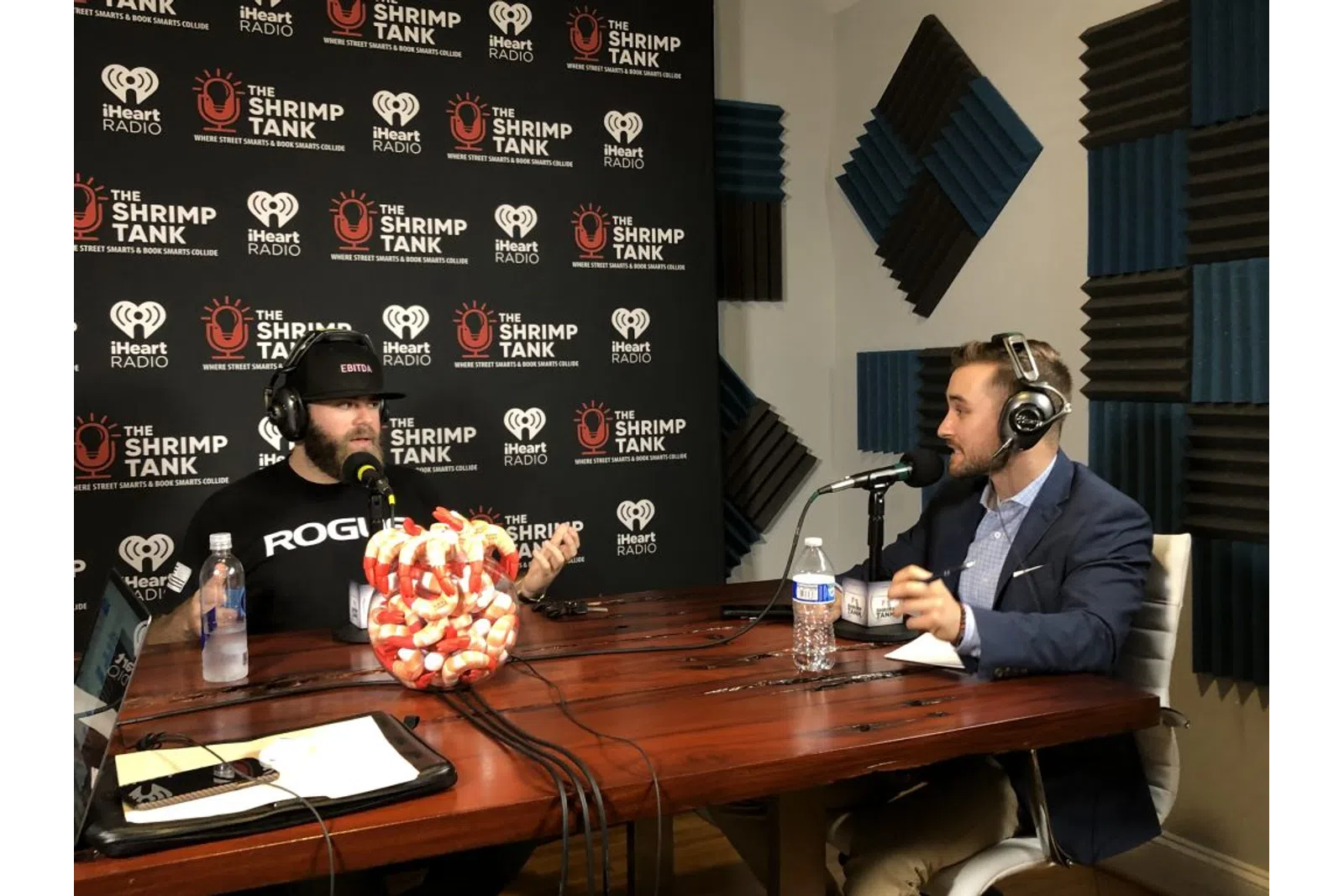a man wearing headphones and sitting at a table with a microphone