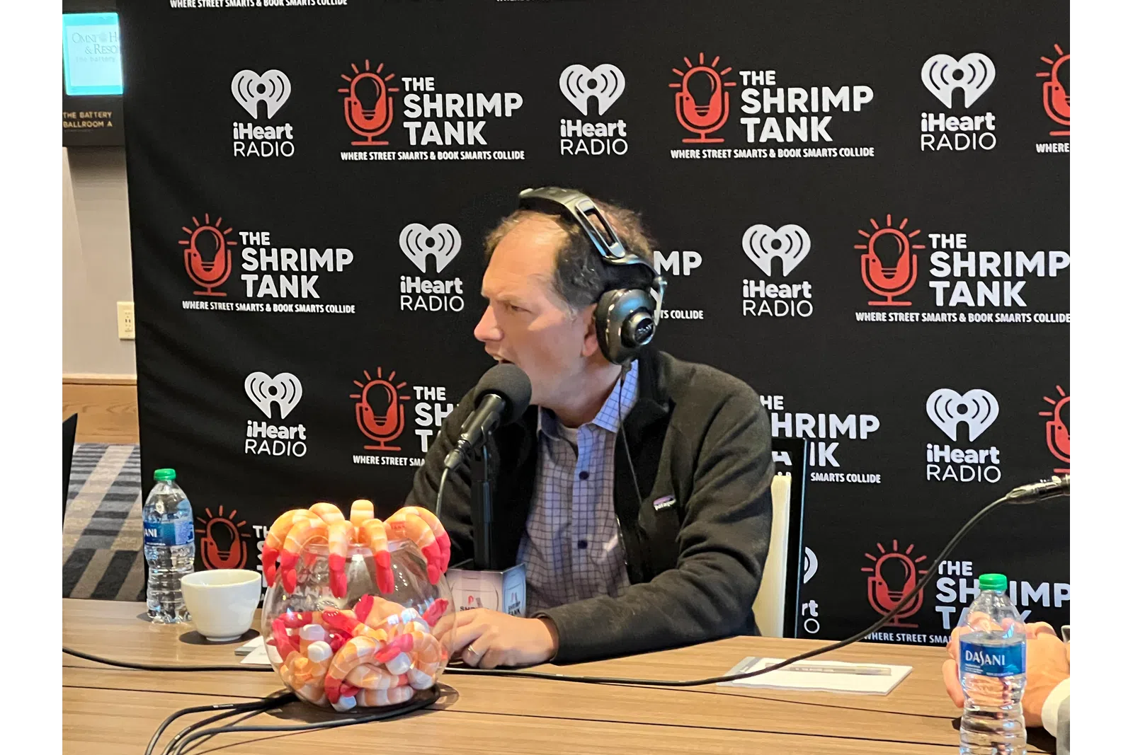 a man wearing headphones and sitting at a table with food