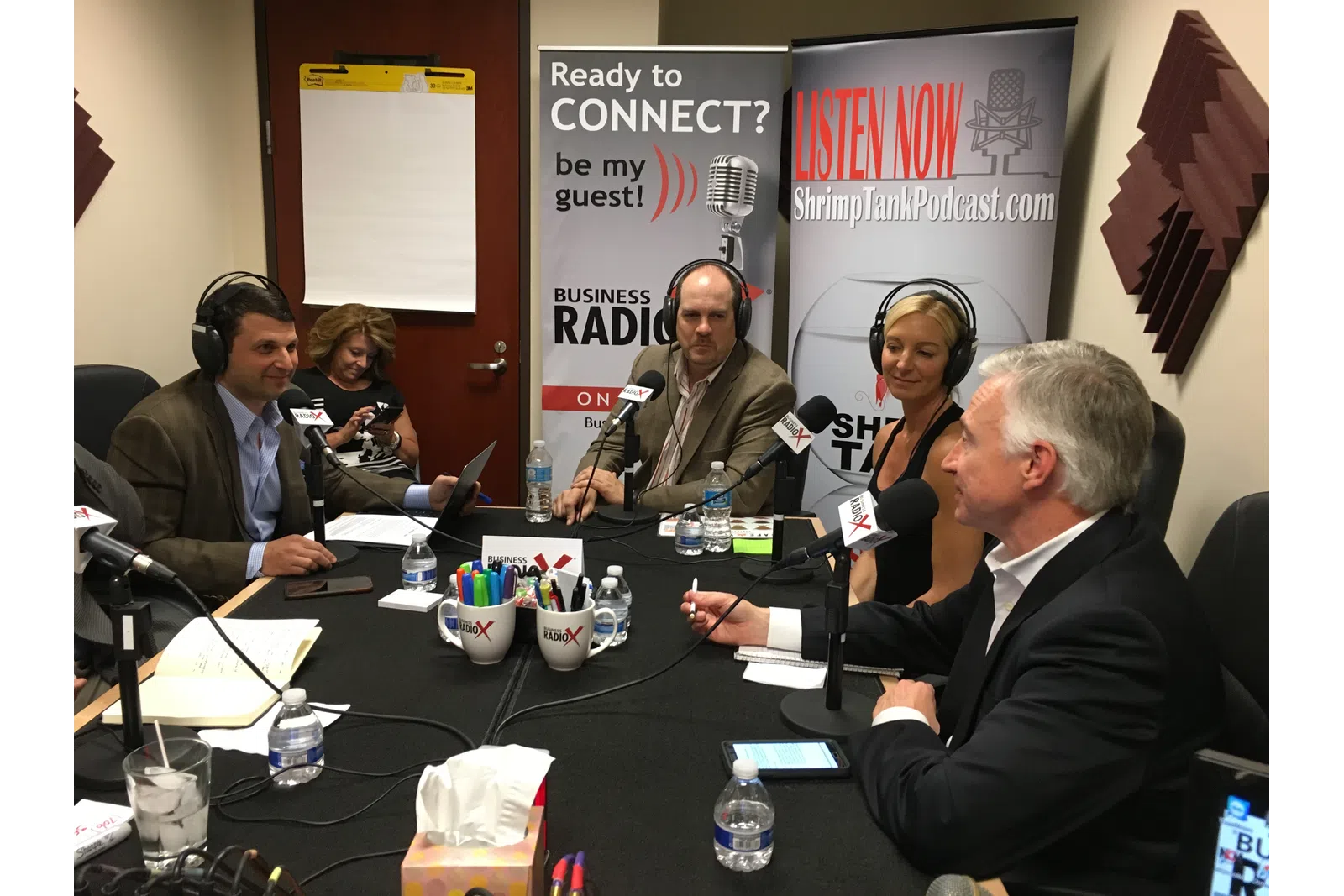 Tammy Stokes et al. sitting at a table with microphones