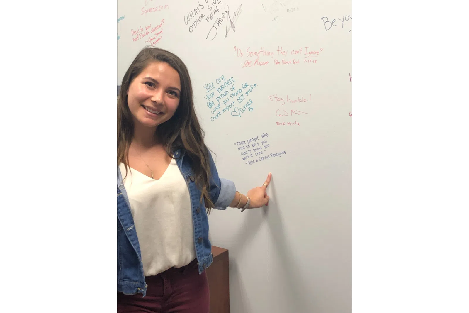 a person writing on a whiteboard